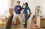 Couple having fun dancing whilst moving house