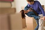 Couple dancing together whilst moving house