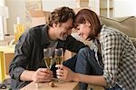 Couple sharing champagne break whilst moving