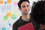 Female and male office workers chatting