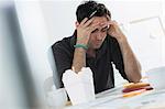 Portrait of male office worker with hands  on head