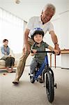 Boy learning to ride bicycle