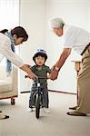 Boy learning to ride bicycle