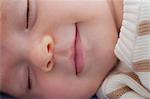 Baby boy sleeping and smiling, close up