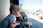 Male toddler looking out of window at Los Angeles airport