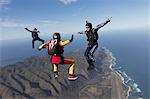 Three formation skydivers free falling