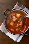 Still life of ladle serving from casserole dish