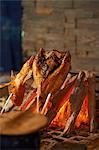 Still life with fish cooking on charcoal