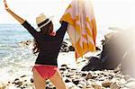 Young woman holding up towel, Palos Verdes, California, USA