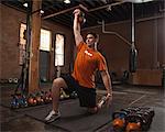 Bodybuilder using kettlebells in gym