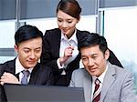 a team of asian business people working together in office.