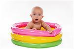 Baby swimming in kid inflatable pool, isolated on white background