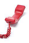 Red Telephone Handset Lying On White Background