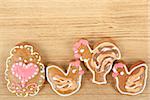 Easter gingerbreads rooster and hen on wooden background