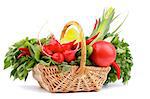 Vegetable Basket with Radish, Basil, Chili Pepper, Bell Pepper, Cucumbers, Leek, Parsley and Tomato isolated on white background