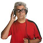 Handsome mature man listening with headphones on white background