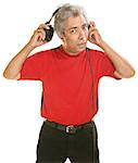 Middle aged Hispanic man removing large headphones