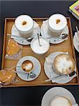 Cappuccino and sweets on a tablet for a coffee break