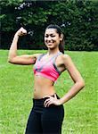 Young fit woman flexes her muscles