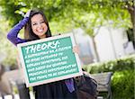 Excited Mixed Race Female Student Holding Chalkboard With Thoery and the Definition Written on it.