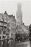 Bruges water canal and Belfry tower in monochrome vintage, Belgium