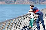 handsome young man and his son enjoying the sea view in san francisco