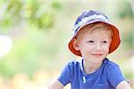 portrait of a relaxed smiling boy in a sunhat