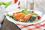 Macaroni with shrimps on a wooden background