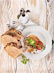 Pork steak with bread on a wooden background