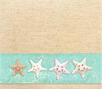 Background with starfishes on canvas texture