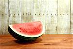 Watermelon Fruit Sliced Sitting on a Wooden Surface