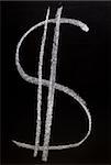 Dollar sign written on blackboard with white chalk