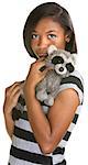 Sad Hispanic teenage girl holding plush raccoon doll