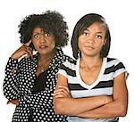 Black mother with teenage daughter on isolated background