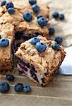 Piece of homemade blueberry cake with berries around