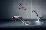 Bloody hand in kitchen sink, Halloween concept