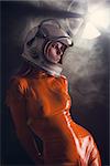 Portrait of sexy girl in orange latex catsuit and space helmet, sci-fi setting