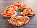 Delicious tomato bruschetta with herbs on a wooden board