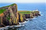 View of Neist Point lighthouse and rocky ocean coastline, highlands of Scotland