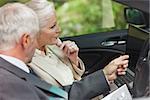 Business people working together in classy cabriolet on a bright day