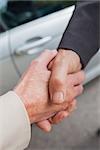 Close up on business people shaking hands after agreement