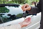 Close up on business man giving his keys to his partner to go to a meeting