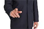 Businessman pointing finger at camera on white background