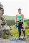 Attractive rock climber smiling at camera in the countryside