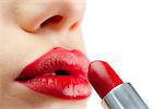 Extreme close up on red lips being made up on white background