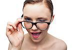 Cheerful model winking at camera over her classy glasses on white background