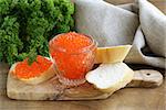 delicacy appetizer red caviar on a white baguette