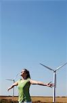 Young woman mimicking wind turbines