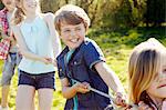 Close up of group of children playing tug o war