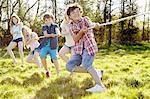 Group of young children playing tug o war